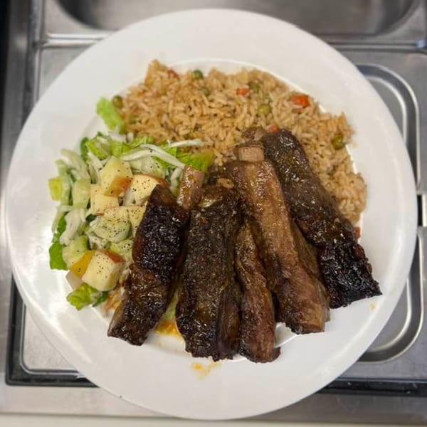Pam's Caribbean Kitchen's ribs with rice and peas, and a side salad with apples.
